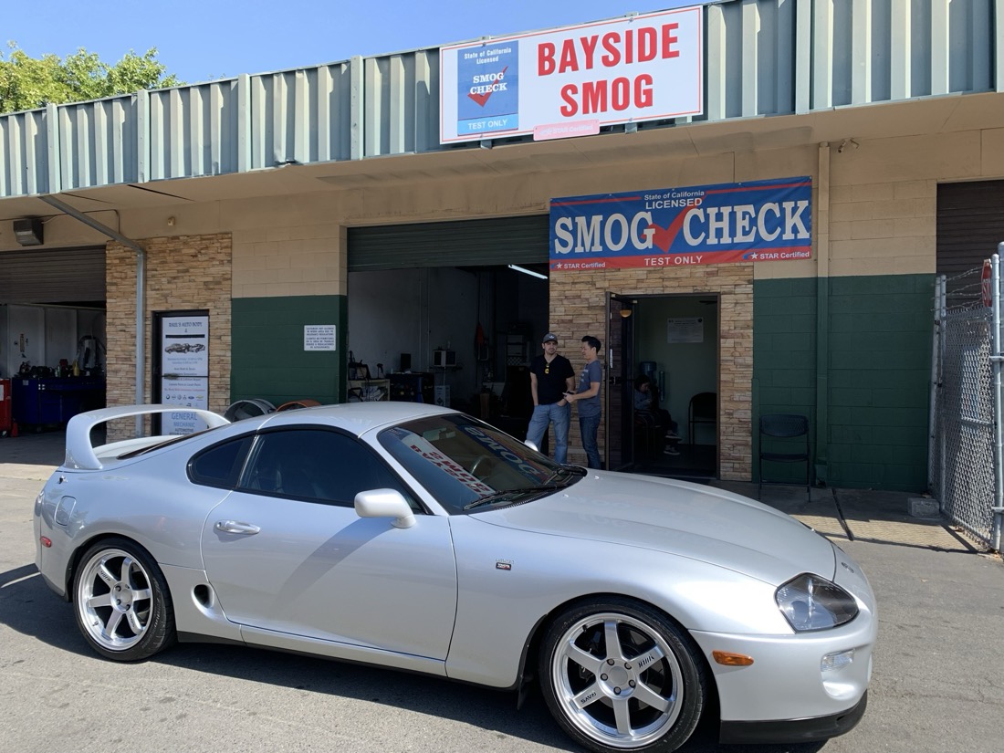 A silver Toyota Supra at the Bayside Smog storefront in Concord