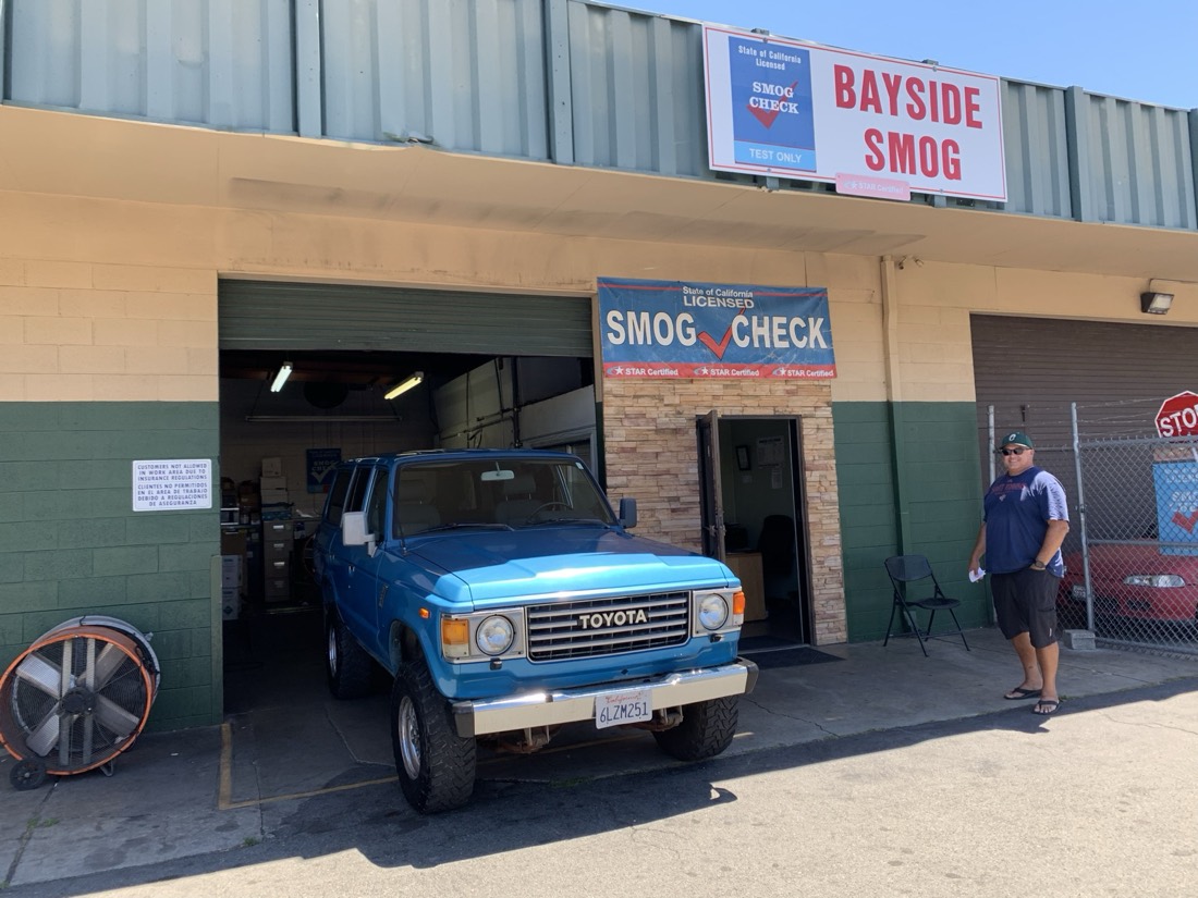 The Bayside Smog storefront with a Toyota Land Cruiser at the bay