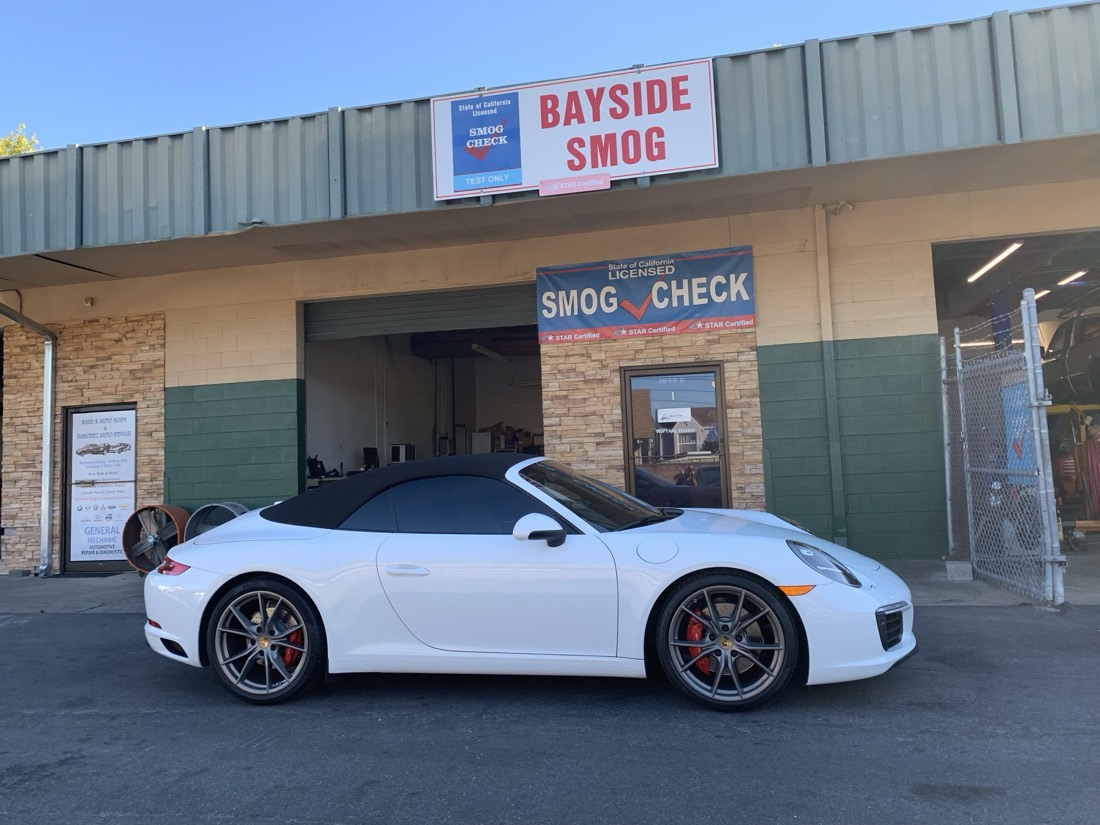 A white Porsche 911 at the Bayside Smog storefront in Concord